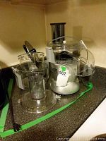 Full view of the Veggie Bullet base with attached accessories on kitchen counter.