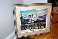 Framed oil on board landscape painting with signature visible on lower left corner.