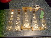 Five 1967 Canadian uncirculated coin sets in plastic holders, showing front face with coins from penny to large silver coin.