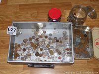 Full view of metal tray and smaller trays with assorted coins and two glass jars containing more coins