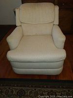 Front view of the white fabric manual recliner chair showing textured fabric, thick cushions, and structured armrests.