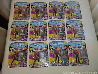 12 Star Trek The Next Generation action figures displayed, 6 unopened in original packaging and 6 opened figures out of packages, arranged in four rows on a beige surface.