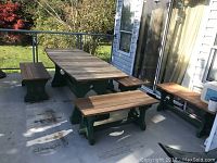 Full view of table and all four benches on patio