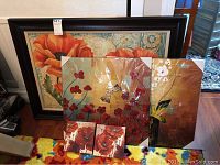 All five pieces of floral wall art arranged together showing the variety of sizes and designs.