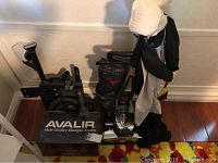 Kirby vacuum cleaner with attachments, Multi Surface Shampoo System box, and vacuum cover on hardwood floor near wall.