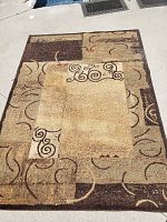 Top view of rectangular area rug displaying the full patterned surface on a concrete floor.
