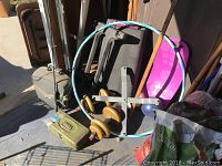 Photo showing the Simply Fit Board exercise stepper, hula hoop, green tackle box, and body shaping stepper with wooden wheels.