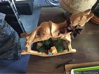 Wooden rocking horse Christmas ornament with bow and mini tree base on table