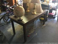 Top and side view showing scratches and wear on dark finished wooden table.