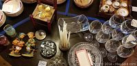 Main view of assorted items including American Brilliant crystal bowl, stemware glasses, figurines, and decorative pieces on table.