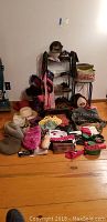 Photo showing multiple purses and hats arranged around a wire rack and stool