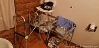 Lot overview showing walker, shower chair, medical devices, and commodes