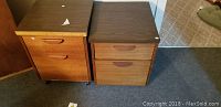 Two pressed wood file cabinets side by side showing overall condition, drawer handles, and missing veneer on one cabinet.