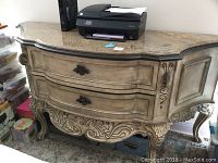 Full front view of granite top wood dresser showing two curved drawers with bronze rose knobs, detailed carvings on legs and front apron.