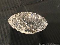 Clear crystal football-shaped paperweight with detailed diamond and crosshatch cuts