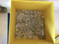 Yellow box filled with large clear crystal prisms for chandelier