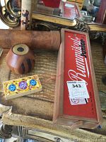 View of large wooden kaleidoscope, smaller round kaleidoscope, Rummikub Junior box and wooden magic trick box showing overall lot contents.