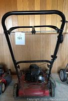 Front view of red Sprint self-propelled mower with handlebar and engine visible, showing condition and structure