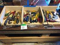 Overview of the lot showing a wooden divider tray filled with screwdrivers, Allen keys, and small wrenches on a workbench.