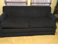 Front view of a dark blue fabric La-Z-Boy sofa with dotted pattern, shows its full length and armrests clearly.
