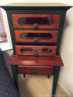 Front view of display cabinet stacked on table showing overall design and condition