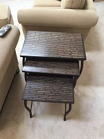 Three metal leg nesting tables stacked, showing rectangular tops with patterned surfaces and metal legs.