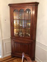 Front view of the full cabinet showing upper glass display and lower door closed