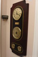 Full view of the Hampton wall-mounted clock and barometer combo in wooden plaque.