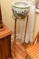 Full view of the metal bamboo look plant stand with planter on top, showing general condition and style