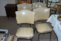 Four vintage vinyl chairs with chrome frames arranged together showing overall wear.