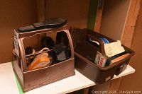 Image showing two brown plastic cases holding assorted shoe shine brushes and related accessories.