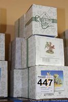 Stacked boxes of Charming Tails figurines by Fitz and Floyd showing branding and box designs.