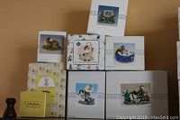 Photo of all six boxed Fitz and Floyd Charming Tail figurines, showing varying box designs and figure images.