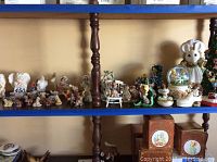 Wide shelf view showing many mouse figurines by Enesco, some animal miniatures, and a water globe by San Francisco Music Box Co with mouse inside a clear dome.