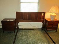 Two Mid-Century Modern style wooden nightstands alongside a wooden headboard, showing overall condition and size.