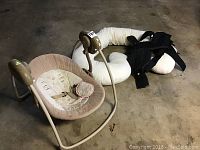 Photo of Baby Bjorn baby carrier, Boppy swing, and LeachCo body pillow on the floor.