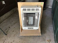 Full heater unit mounted on wheeled wooden platform seen from front.
