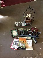 Full view of the lot with all decorative items, signs, stand and books arranged on floor