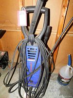 Front view of blue Simoniz S1650 pressure washer showing power cord wrapped around center section.