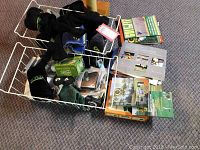 Photo showing golf club covers, golf balls, gloves, and packaging boxes, with golf books and magazines on the floor.