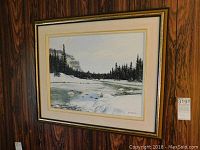 Framed signed oil painting depicting a winter landscape with snow, trees, and a river.