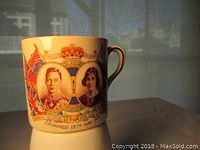 Full side view of the ceramic commemorative mug showing the images of King George VI and Queen Elizabeth and the coronation date.