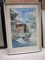 Full view of the watercolor painting showing the framed artwork with Indian waterfront scene