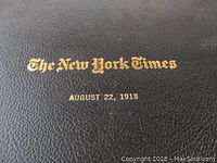 Close-up image of the black leather binder cover embossed with gold text "The New York Times August 22, 1918".