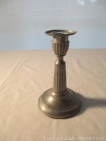 Full view of the antique pewter candle stick showing overall design and height of 5.5 inches.