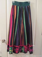 Front view of colorful Jeanne Marc culottes with vertical multicolor stripes and checkered waistband.