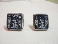 Front view of the pair of Egyptian Revival square cufflinks with blue on white hieroglyphs.