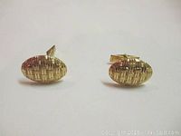 Front view of pair showing oval faces with basketweave pattern