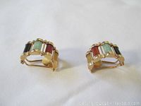 Front view of both earrings showing colored stone segments in gold frames.