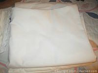 Folded white sheet showing texture and condition.